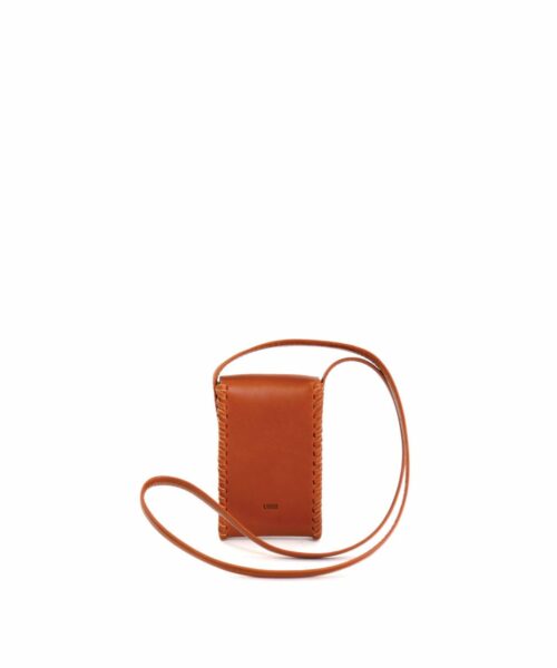LUMI Kimmo Neck Phone Case, in cognac, is created using natural vegetable tanned cow leather. The color will naturally change over time.